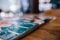 Kaboompics - Magazines on a wooden desk