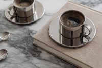 Kaboompics - Chrome Coffee Cup on Beige Books over Arabescato Marble
