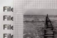 Kaboompics - Close Up of Analogue Seascape Print with Files Typography