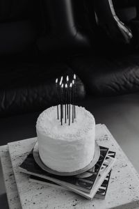 Kaboompics - Black and White Cake with Lit Candles