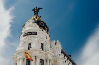 Kaboompics - Narrow Madrid Street Between Historic Facades with a Distant Bell Tower