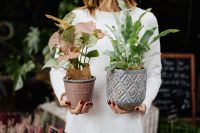 Kaboompics - Woman holding flebodium & caladium