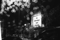 Kaboompics - Black-and-white huge design billboard through a wet car window