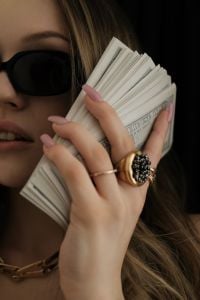 Kaboompics - Woman Holding a Stack of Cash Wealth Mindset Motivation