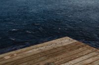 Kaboompics - Weathered Wooden Dock over Deep Blue Lake Water