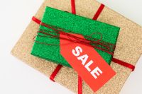 Kaboompics - Green Gift Box with Red Sale Tag on Gold Wrapped Present