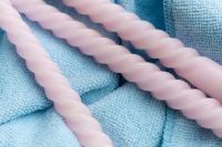 Kaboompics - Pastel Twisted Candles On Blue Textile Background