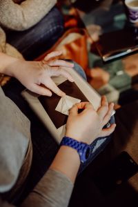 Kaboompics - Woman Folding Paper While Seated at a Craft Workshop