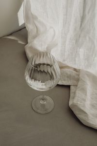 Kaboompics - Overhead Still Life of an Empty Wine Glass and Draped White Linen