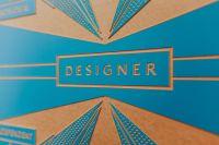 Kaboompics - Designer Title Panel and Geometric Motif on Blue and Tan Branding Background