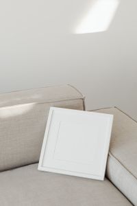 Kaboompics - Square Photo Frame Mockup on Beige Sofa with Copy Space