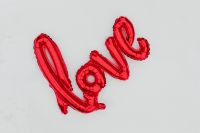 Kaboompics - Red LOVE Balloon Lettering on White Snow