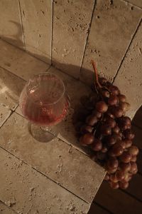 Kaboompics - Red Grapes and Rose Wine Glass on Stone Surface