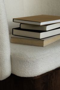 Kaboompics - Close-Up Reading Aesthetic of Books on Textured Cream Chair