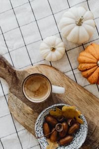 Kaboompics - Coffee Acorns and Mini Pumpkins on a Wooden Board