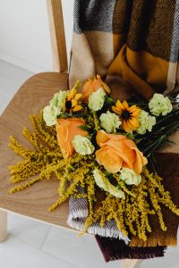 Kaboompics - Orange and Yellow Autumn Flower Arrangement on Chair