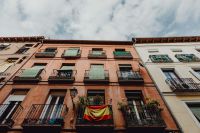 Kaboompics - Wide Upward View of Madrid Peach and White Apartment Facades Under Clouds
