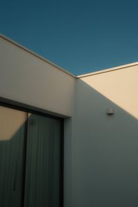 Kaboompics - Minimalist White Exterior Wall and Window with Triangular Shadows