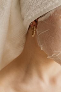Kaboompics - Close-Up of Woman in a Sheet Mask with a Gold Hoop Earring