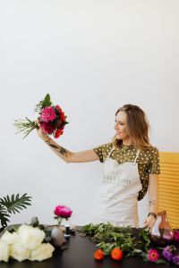 Kaboompics - Florist Presenting a Colorful Bouquet with an Outstretched Arm