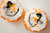 Kaboompics - Close Crop of Orange Roe Sushi Roll with Seaweed and Cucumber