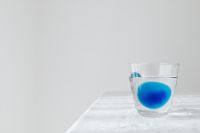 Kaboompics - Blue Water Glass Still Life on White Linen, Minimal Drink Brand Background