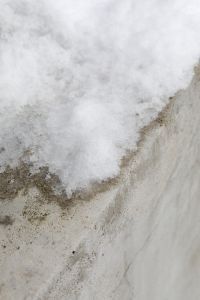 Kaboompics - Fresh Snow Clinging to a Rough Garden Wall, Minimal Winter Texture