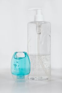 Kaboompics - Blue Travel Sanitizer Beside Clear Pump Bottle