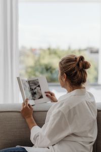Kaboompics - Woman Reading a Magazine by a Bright Window