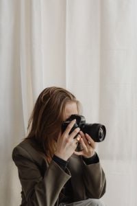 Kaboompics - Young Female Photographer Taking Portrait with DSLR Camera