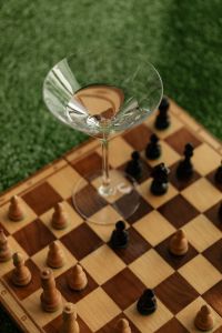 Kaboompics - Chessboard and Cocktail Glass on Green Grass