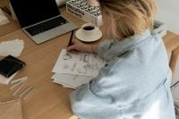 Kaboompics - Overhead Interior Design Sketching Workspace with Laptop and Coffee