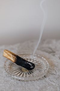 Kaboompics - Palo Santo Incense Smoke Rising from Glass Dish on Textured Marble