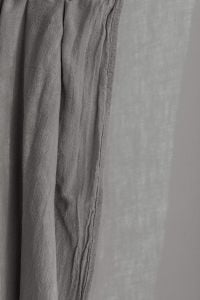 Kaboompics - Gray Curtain Panel with Fine Wrinkles against a Pale Wall, Neutral Background