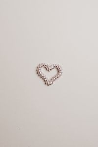 Kaboompics - Pearl Bead Heart on a Beige Background with Minimal Copy Space
