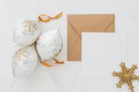 Kaboompics - Blank White Holiday Card, Kraft Envelope and Snowflake Baubles