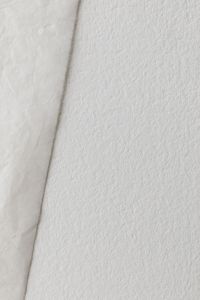 Kaboompics - Paper Sheet Against Textured Wall Minimal Background