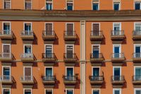 Kaboompics - Orange Naples Tenement Facade With Repeating Balconies