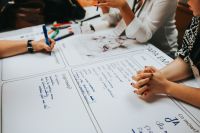 Kaboompics - Creative Team Brainstorming Around Workshop Planning Sheets