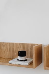 Kaboompics - Close-Up Black Candle and Marble Plinth on Wood Shelf