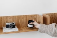 Kaboompics - Hand Styling Wooden Shelf with Candle, Vintage Camera and Books