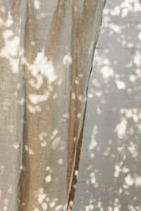 Kaboompics - Sunlit Linen Drapes Against a Minimal Wall