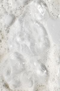 Kaboompics - Glossy Clear Gel Drops and White Bubbles on a Soft Skincare Foam Background