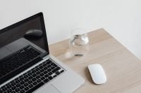 Kaboompics - Laptop with Mouse and Glass of Water on Desk