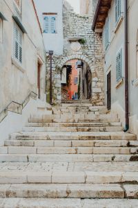 Kaboompics - White Stone Staircase beneath an Old Archway in Rovinj Old Town