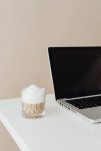 Laptop and a glass of Cafe Latte on the desk