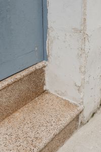Kaboompics - Blue Door, Worn Plaster and Terrazzo Stone Steps