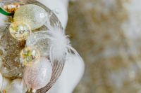 Kaboompics - Close-Up Glass Easter Egg Ornaments with White Feathers and Open Copy Space
