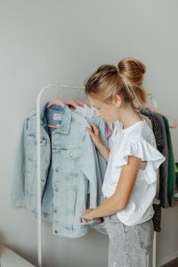 Kaboompics - Teenage Girl Looking through Pastel Clothes on a Bedroom Rack, Wardrobe Styling