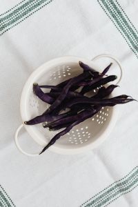 Kaboompics - Top View of Purple Beans in a White Colander